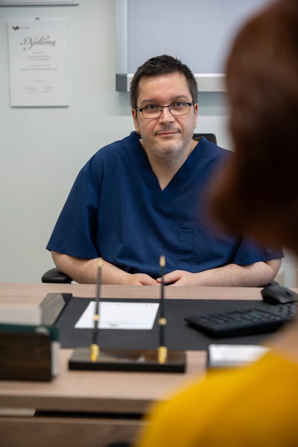 Dr Koutsouflianiotis talking to a patient in his office